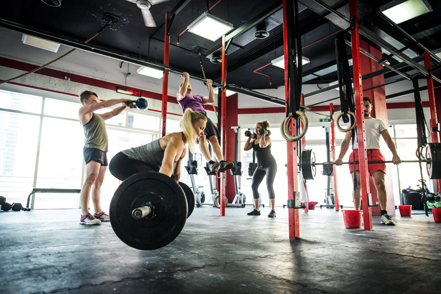 Muscular athletes training in a crossfit gym - Functional training workout in a gym
